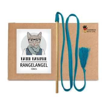 Ein Katzenspielzeugset mit einem Holzstab, türkisfarbenem Faden und Quaste, verpackt mit einer Cartoonkatze und beschriftet mit "KATER KASIMIR RANGELANGEL TÜRKIS."