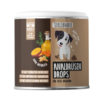 Runde Dose mit der Aufschrift 'Tierliebhaber Analdrüsen Drops' zeigt einen Cartoon-Hund, Abbildungen von Früchten und Öl sowie den deutschen Text 'für feste Häufchen'.