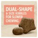 Image of pet food kibble with text "DUAL-SHAPE & SIZE KIBBLES FOR SLOWER CHEWING" on a light background.