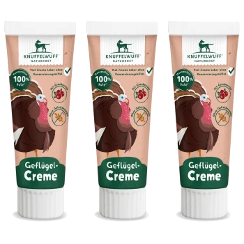 Drei Tuben Knuffelwuff Geflügel-Creme mit einem Cartoon-Puten, gekennzeichnet mit "100% Pute," mit Symbolen für Cranberries und getreidefrei.