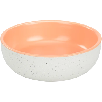 Un bol de nourriture pour animaux rond avec un extérieur blanc tacheté et un intérieur lisse pêche.