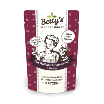 Betty's Landhausküche Katzenfutterverpackung zeigt einen Koch, eine Katze und Text über Truthahn, Barnetsöl, Taurin und Ernährung für erwachsene Katzen.
