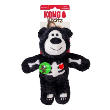 Black plush KONG Wild Knots bear toy with white skeleton, red heart and green FEEL ME! sticker.