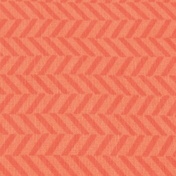 Ein strukturierter Stoff in Korallenfarbe mit einem sich wiederholenden Fischgrätenmuster.