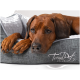 Ein gemütliches Hundebett mit einem grauen Stoffäußeren und einem weichen weißen Inneren, mit dem Text "TrendPet VitaBed."