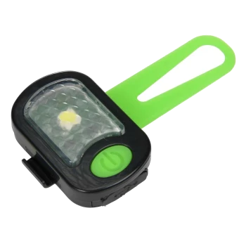Lumière de sécurité pour animaux de compagnie noire et verte avec un objectif à motif de diamant et une sangle verte pour l'attache.