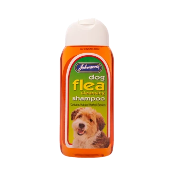 Johnson's dog flea cleansing shampoo bottle, orange with green label, stating "Contains Natural Herbal Extracts."