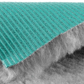 Nahaufnahme einer türkisfarbenen Haustierbürste mit weichen grauen Borsten aus einem Online-Tiergeschäft.