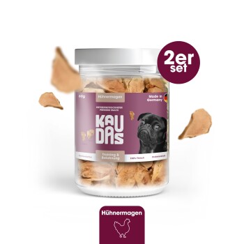 Hundeleckerlis in einem klaren Glas mit dem Etikett "KAUDAS Hühnermagen," mit einem schwarzen Hund auf der Vorderseite, mit "Training & Belohnung" und "Made in Germany."