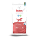Eine Tüte Husse Opus Farm Hundefutter, mit einer getreidefreien Formel, mit einem Cartoon-Hundelogo, das "84% tierisches Protein" und "38% Protein" angibt.