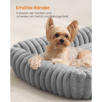 Kleiner Hund liegt auf einem plüschigen, grauen Haustierbett mit erhöhtem Rand, deutscher Text über Nackenentlastung und Komfort.