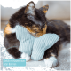 Eine dreifarbige Katze kuschelt mit einem hellblauen, schmetterlingsförmigen Spielzeug, beschriftet mit "Gefüllt mit Katzenminze oder Baldrian," auf einer weichen Oberfläche.