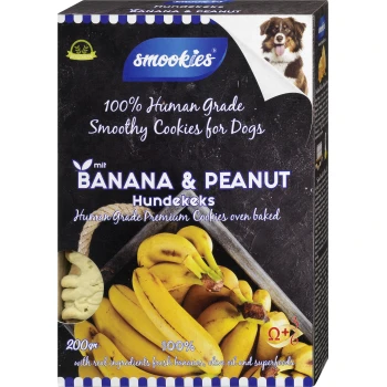 Verpackung für Smookies Hundekekse mit Bananen- und Erdnussgeschmack, gekennzeichnet mit '100% Human Grade', mit Bildern von Bananen und einem Hund.