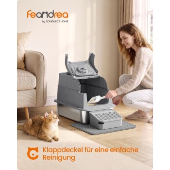 Graue feandrea abgedeckte Katzentoilette wird von einer Frau ausgeschaufelt, orangefarbene Katze in der Nähe; sichtbarer Text: 'feandrea by SONGMICS HOME'