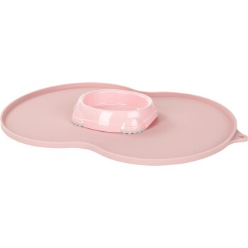 Pink pet feeding mat with a removable bowl, featuring a non-slip design and a rounded shape.