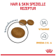 Hundefutterkroketten mit dem Etikett "Haar & Haut Spezielle Rezeptur" mit Symbolen für Vitamine und Omega-3 & -6, mit einer vergrößerten Kroketten.
