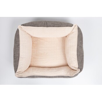 Ein gemütliches Haustierbett mit einem weichen, cremefarbenen Innenraum und einem strukturierten grauen Äußeren, entworfen für Komfort und Stil.