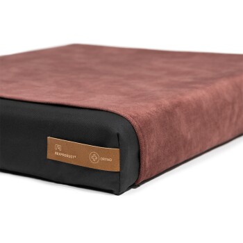 Orthopädisches Haustierbett mit einer weichen braunen Oberseite und schwarzen Seiten, mit einem Etikett, das "Rexproduct® Ortho" liest.