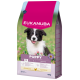 Sac de nourriture pour chiot Eukanuba 12 kg avec chiot noir et blanc souriant, grand texte « EUKANUBA » et « PUPPY 10-25 KG »
