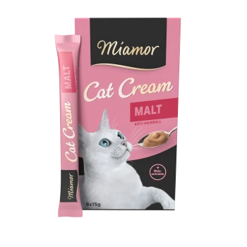 Miamor Cat Cream in einer rosa Box, mit einer weißen Katze, die nach oben schaut, beschriftet mit "MALT" und "ANTI-HAIRBALL", mit einem Löffel voll Creme.