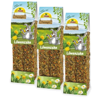 Drei Packungen JR Farm Löwenzahn Haustier-Leckerlis, mit einem Cartoon-Hasen und Löwenzahn, vor einem grünen Wiesenhintergrund.