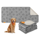 Ein Golden Retriever mit einem orangefarbenen Halstuch sitzt neben einer grauen Haustiermatte mit einem gesteppten Design, mit einem Stapel ähnlicher Matten in der Nähe.