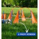 Ein weißer Hund navigiert einen Agility-Kurs mit orangefarbenen Hürden und Reifen auf Gras, mit dem Text "2 PROFI HÜRDEN."