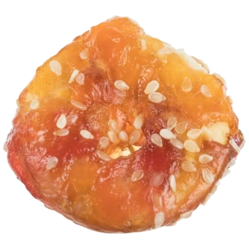 A round, chewy pet treat with a glossy, orange-brown surface, sprinkled with white sesame seeds.