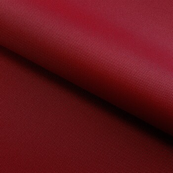 Nahaufnahme eines strukturierten roten Stoffes, möglicherweise für Haustierzubehör, der eine reiche Farbe und ein gewebtes Muster zeigt.