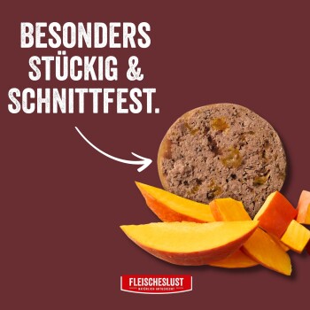 Runder fleischiger Tierfutterfladen mit Mangoscheiben auf bordeauxfarbenem Hintergrund; deutscher Titel „BESONDERS STÜCKIG & SCHNITTFEST.“ und Logo „FLEISCHESLUST“.