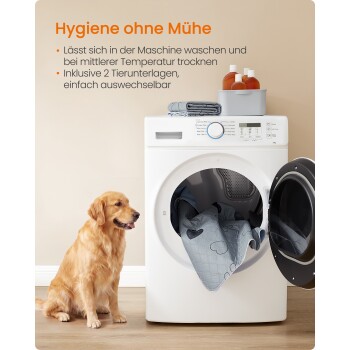 Golden Retriever neben einer Frontlader-Waschmaschine, mit herausragender grauer Haustiermatte und Flaschen obenauf; Wandtext 'Hygiene ohne Mühe'.