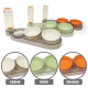 Set aus drei doppelten Futternäpfen mit angebauten Wasserflaschen in Creme, Grün und Orange, beschriftet mit „CREME“, „GRÜN“ und „ORANGE“.