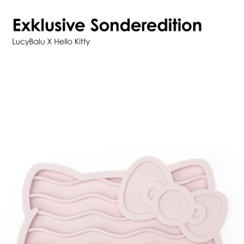Eine Person hält eine graue Silikon-Haustierfütterungsmatte in Form eines Hello Kitty-Gesichts, mit gewellten Linien und einer Schleife, beschriftet mit "LUCY BALU."