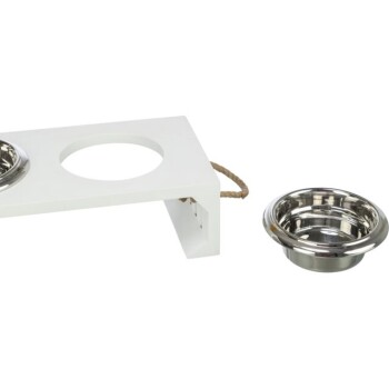 Weiße Holz-Futterstation für Haustiere mit zwei runden Ausschnitten, eine Schüssel fehlt, und eine Edelstahlschüssel steht daneben.