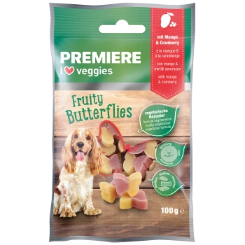 Eine Packung "Premiere I Love Veggies" Fruity Butterflies Hundeleckerlis mit einem Cocker Spaniel und bunten Mango- und Cranberry-Snacks.