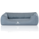 Graues Hundebett mit erhöhten Rändern und einem weichen Kissen, mit dem Logo 'KNUFFELWUFF' auf der Vorderseite.