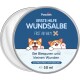 Runde Dose von "Pawlie's First Aid Balm" mit Cartoon-Corgis und deutschem Text zur Behandlung kleiner Wunden.