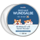 Runde Dose von "Pawlie's First Aid Balm" mit Cartoon-Corgis und deutschem Text zur Behandlung kleiner Wunden.