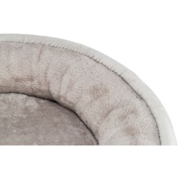 Nahaufnahme eines weichen, runden Hundebetts mit einem plüschigen, beigen Innenraum und einem hellen Rand, ideal für kleine Hunde oder Katzen.