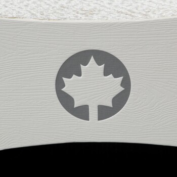 Nahaufnahme eines weißen Haustierprodukts mit einem grauen runden Logo mit einem Ahornblatt-Design, vor einem strukturierten Hintergrund.