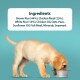A yellow Labrador puppy eats from a metal bowl with ingredients listed above: Brown Rice, Chicken Meal, Oats, Peas, and more.
