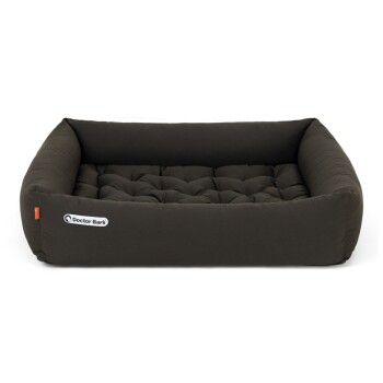 Ein plüschiges, dunkelbraunes Hundebett mit gepolstertem Kissen und einem weißen 'Doctor Bark'-Logo an der Seite.