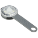 Une cuillère doseuse pour animaux de compagnie Trixie grise avec un dessus circulaire transparent, conçue pour mesurer la nourriture ou les suppléments pour animaux.