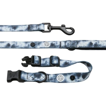 Eine Hundeleine mit blauem Batikmuster, die einen schwarzen Clip, eine verstellbare Schnalle und zwei runde Anhänger zur Kennzeichnung der Nachhaltigkeit aufweist.