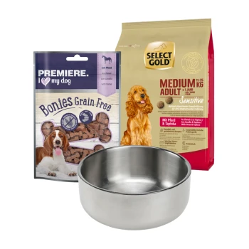 Eine Edelstahlschüssel für Hunde vor "Premiere I Love My Dog Bonies" Leckerlis und "Select Gold Medium Adult Sensitive" Trockenfutter.