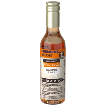 Bottle of Premiere Raw Kitchen Red Salmon Oil for pets, labeled in German and English, showcasing natural ingredients and omega-3 benefits.