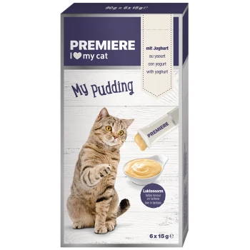 A playful tabby cat reaching for a bowl of creamy pudding, with packaging labeled "PREMIERE I ❤️ my cat My Pudding" and "low in lactose."