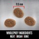 Three oval-shaped pet food pieces on a metallic surface, measuring 11.5 mm, labeled "Wholeprey Ingredients: Meat | Organ | Bone."