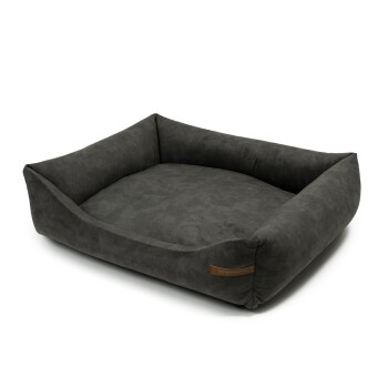 Ein plüschiges, dunkelgraues Haustierbett mit erhöhten Seiten und einem weichen, bequemen Inneren, mit einem kleinen Lederetikett an der Seite.