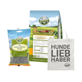 Eine Ausstellung von Haustierprodukten: "Heide-Happen mit Lamm" Hundeleckerlis, Premium-Hundefutterbox und eine Tragetasche mit der Aufschrift "HUNDE LIEB HABER."